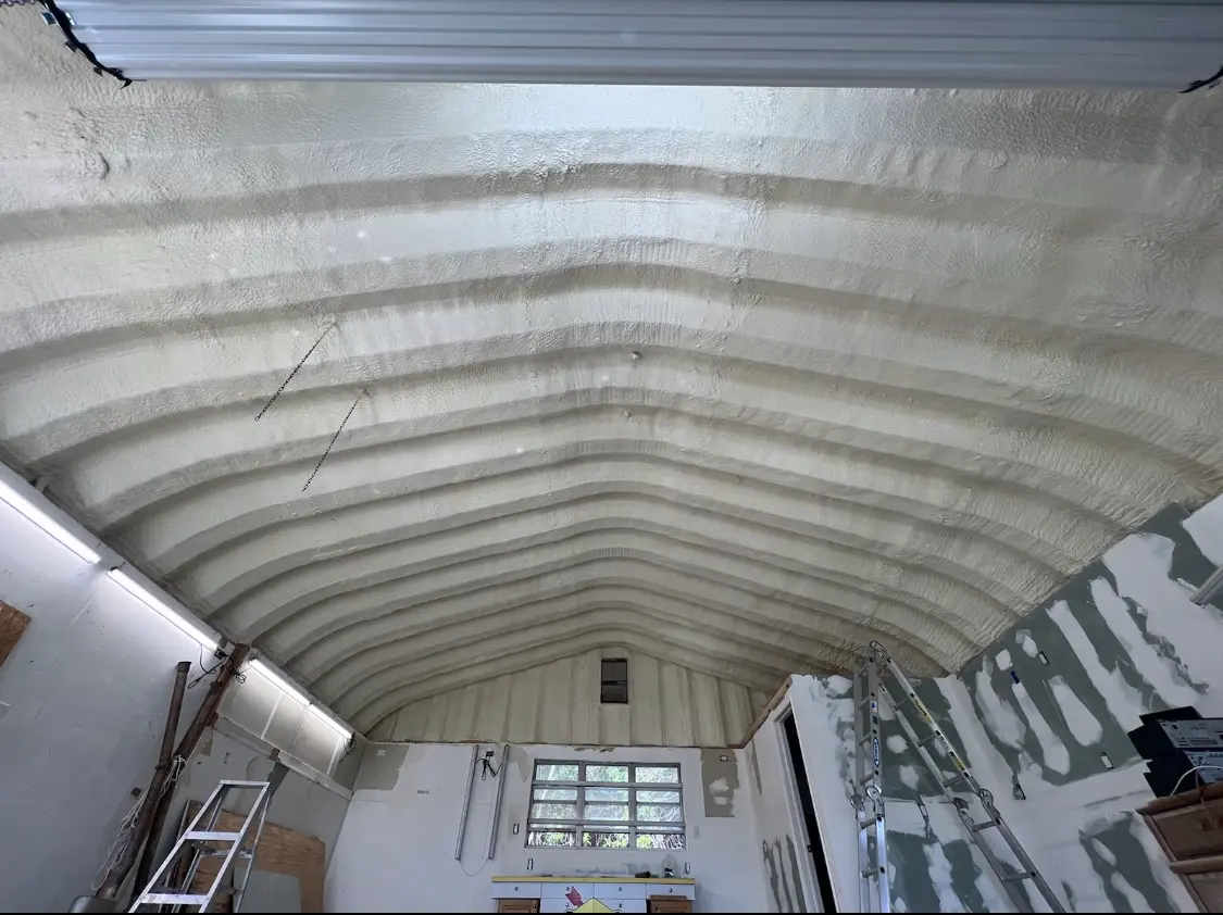Spray polyurethane foam applied to the underside of a metal roof deck in Almont